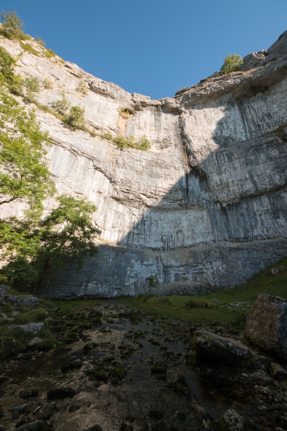 Standing at the bottom of the imposing limestone cliffs. Photos taken at National Trust Malham Cove.